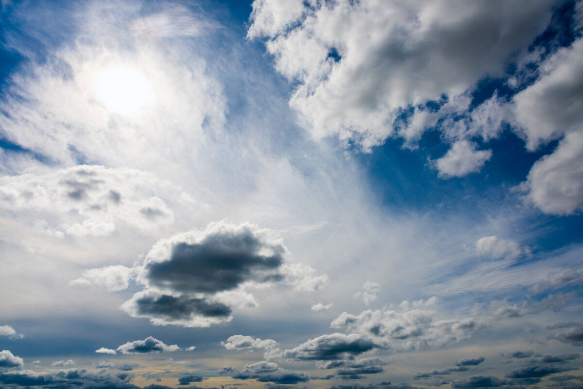 View of sun shining through clouds