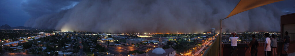 A massive dust cloud races toward viewers on a downtown rooftop. An approaching haboob dust storm captured in Phoenix in 2011. Credit: Christopher Marks via Flickr