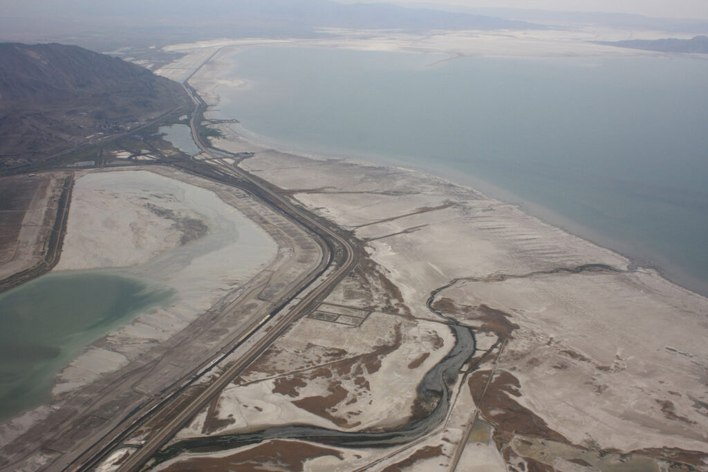 Aerial view of the Great Salt Lake where Interstate 80 traces its receding shoreline. The lake has been rebounding after a couple wet years but its overall level has been in long-term decline. Credit: David Herrera via Wikimedia Foundation