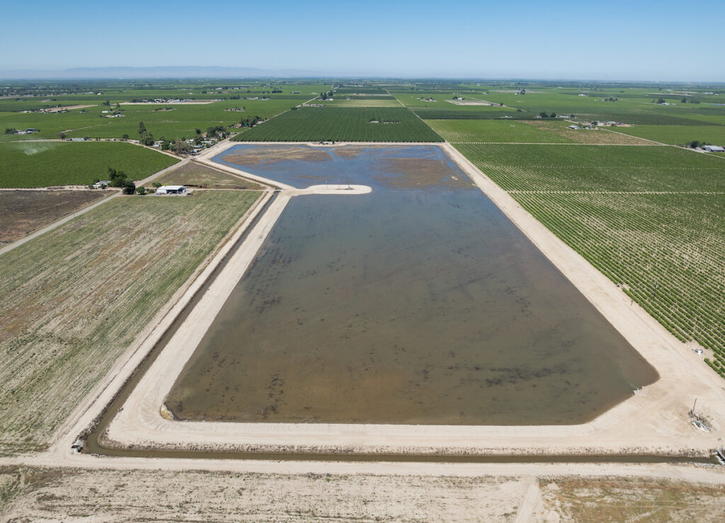 In May 2024, water being diverted for the first time onto land that was converted to a groundwater recharge basin near Caruthers in Fresno County. Xavier Mascareñas / California Department of Water Resources