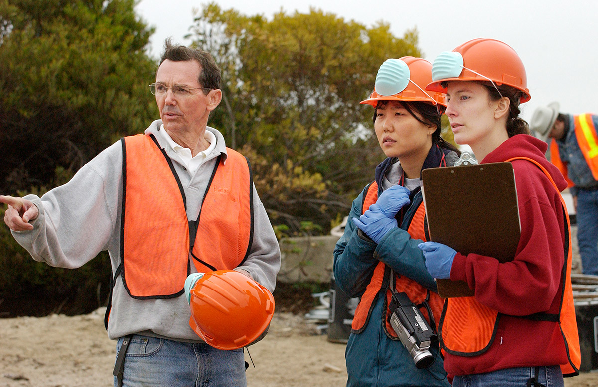 Prof. Richard Luthy and Stanford graduate students discuss an experiment to neutralize pollution at the former site of the Hunters Point Naval Shipyard in San Francisco in 2004. Linda A. Cicero / Stanford News Service