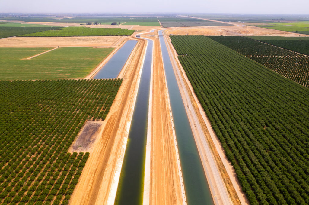 The Friant-Kern Canal in 2024 as a new 10-mile segment, left, neared completion to restore capacity to the subsidence-damaged canal, whose capacity had dropped by 60% due to subsidence. A second phase will bypass another 23-mile segment. 