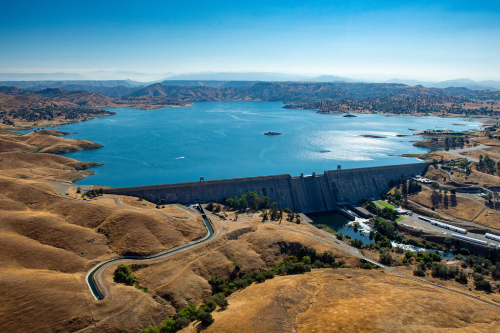 Millerton Lake and Friant Dam, 16 miles northeast of Fresno. in 2013. They provide flood control, conservation storage, and water releases into the Madera and Friant-Kern canals to serve agricultural land in Fresno, Kern, Madera and Tulare counties.  Carl Costas / California Department of Water Resources
