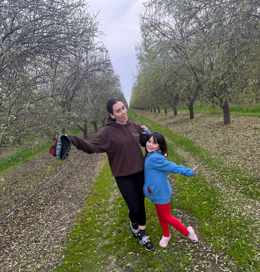 Angela Williams and her sister Andrea at an almond orchard outside their house in Bakersfield. Angela Williams