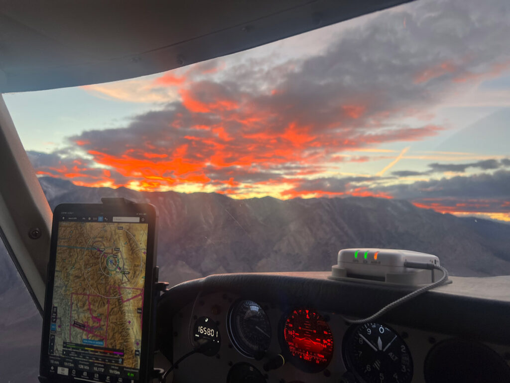 The view out the cockpit window, with a smartphone providing aerial navigation maps.